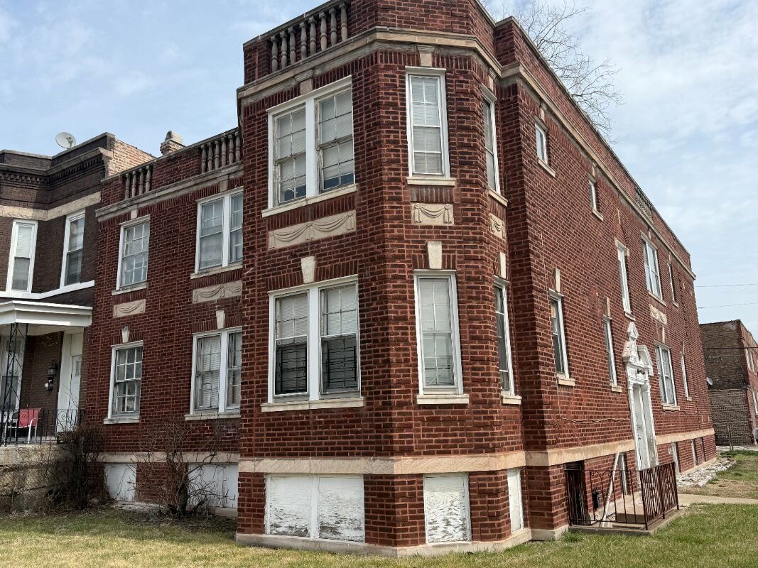 Distressed Chicago brick building purchased as-is by Braddock Investment Group
