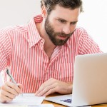 What are Closing Costs | white man on laptop writing