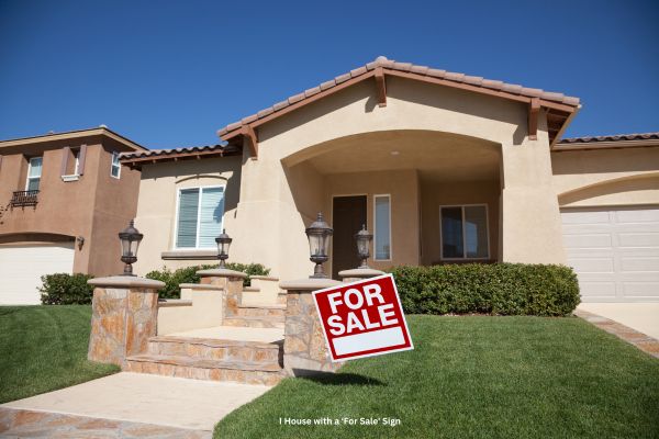 For sale sign in front of an inherited house, representing the process of selling inherited property in Stockton