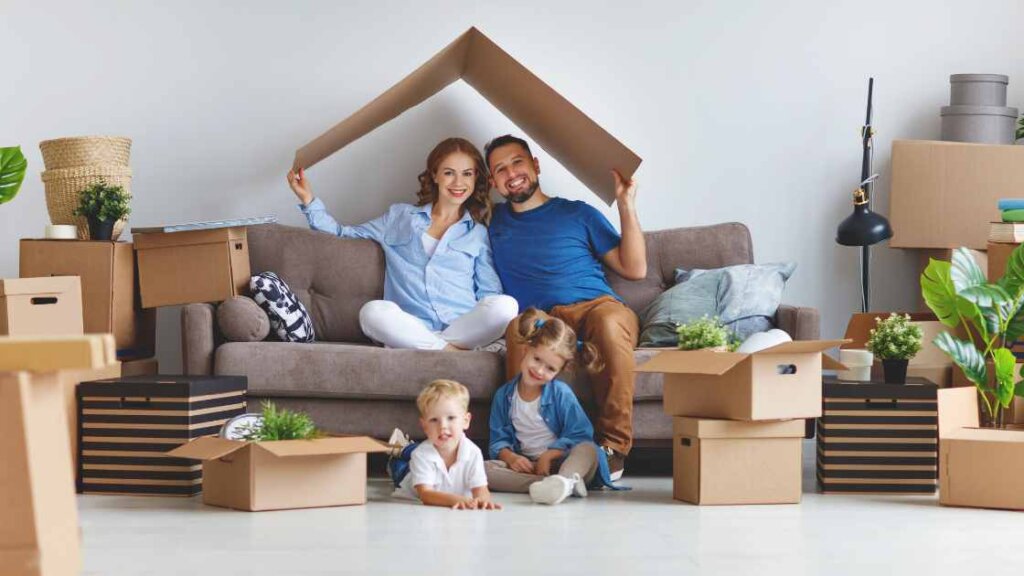 A happy family with moving boxes in their new home