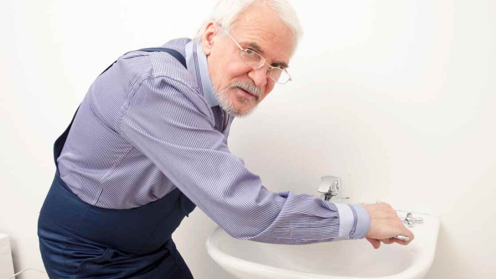 Homeowner carrying out minor repairs on a leaky faucet