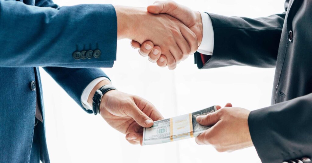Homeowners exchanging house keys for cash from fast cash property buyers