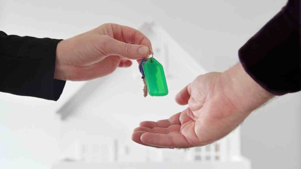 Seller handing over keys to a fast cash home buyer