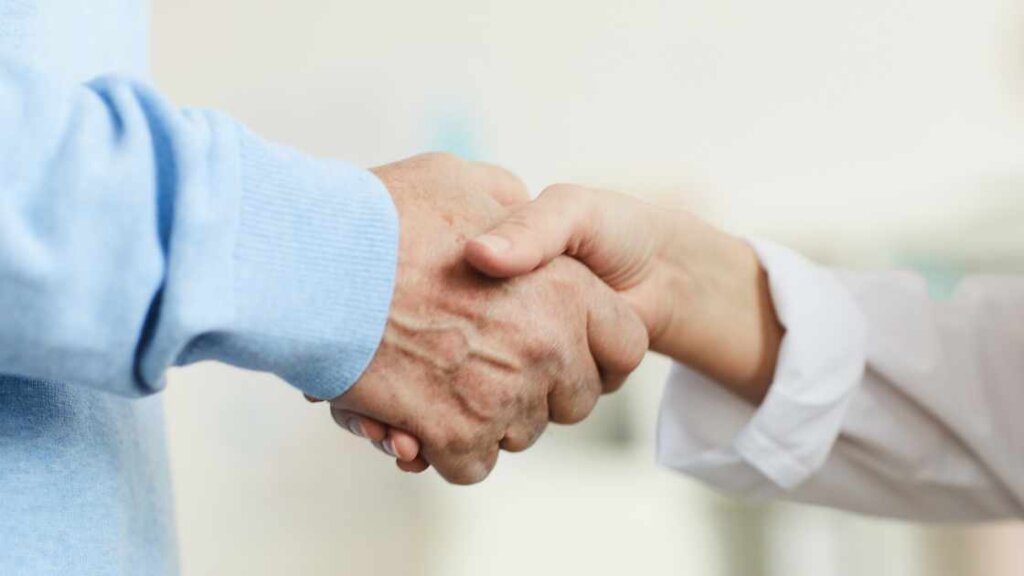 Two hands shaking, symbolizing the importance of legal guidance in ensuring a secure and lawful process in quick house sales