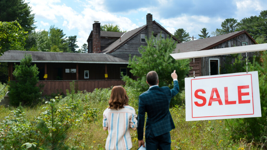 A sign with the text "Condemned" posted on the front of a house, representing the official declaration of the property being unfit for habitation