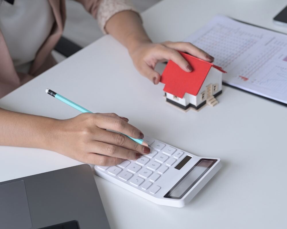 Analyzing financial considerations for an inherited condemned property with calculator and financial charts