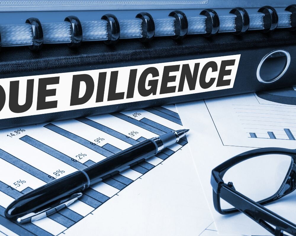 Magnifying glass highlighting the importance of due diligence in property acquisition