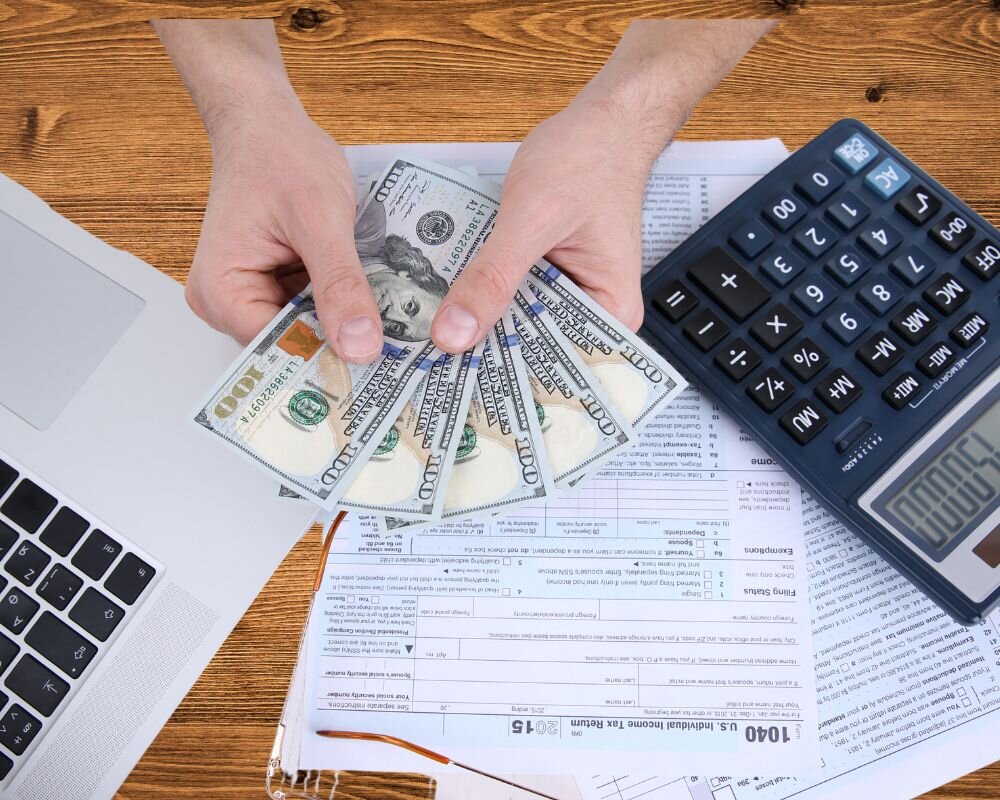 evaluating a cash offer on their home amidst paperwork and a calculator