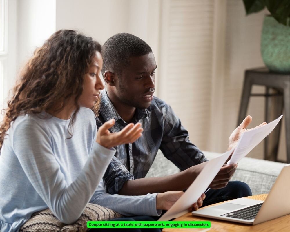 Couple sitting at a table discussing and understanding each other during the asset division process