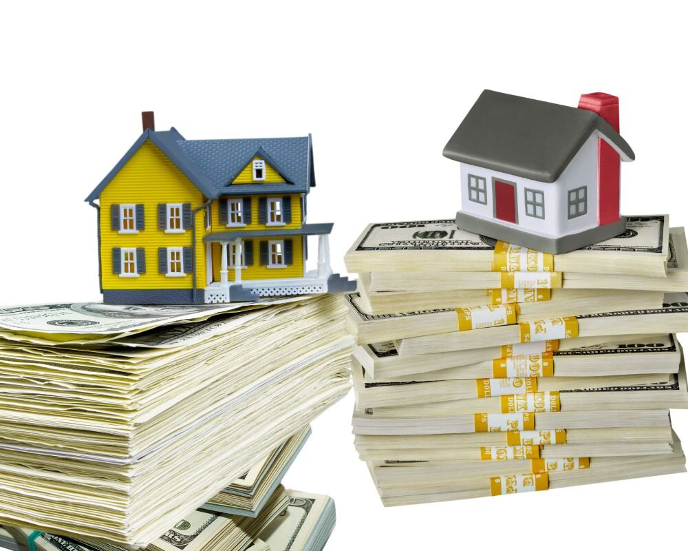 Cash stacks next to a miniature house model, representing a cash home sale