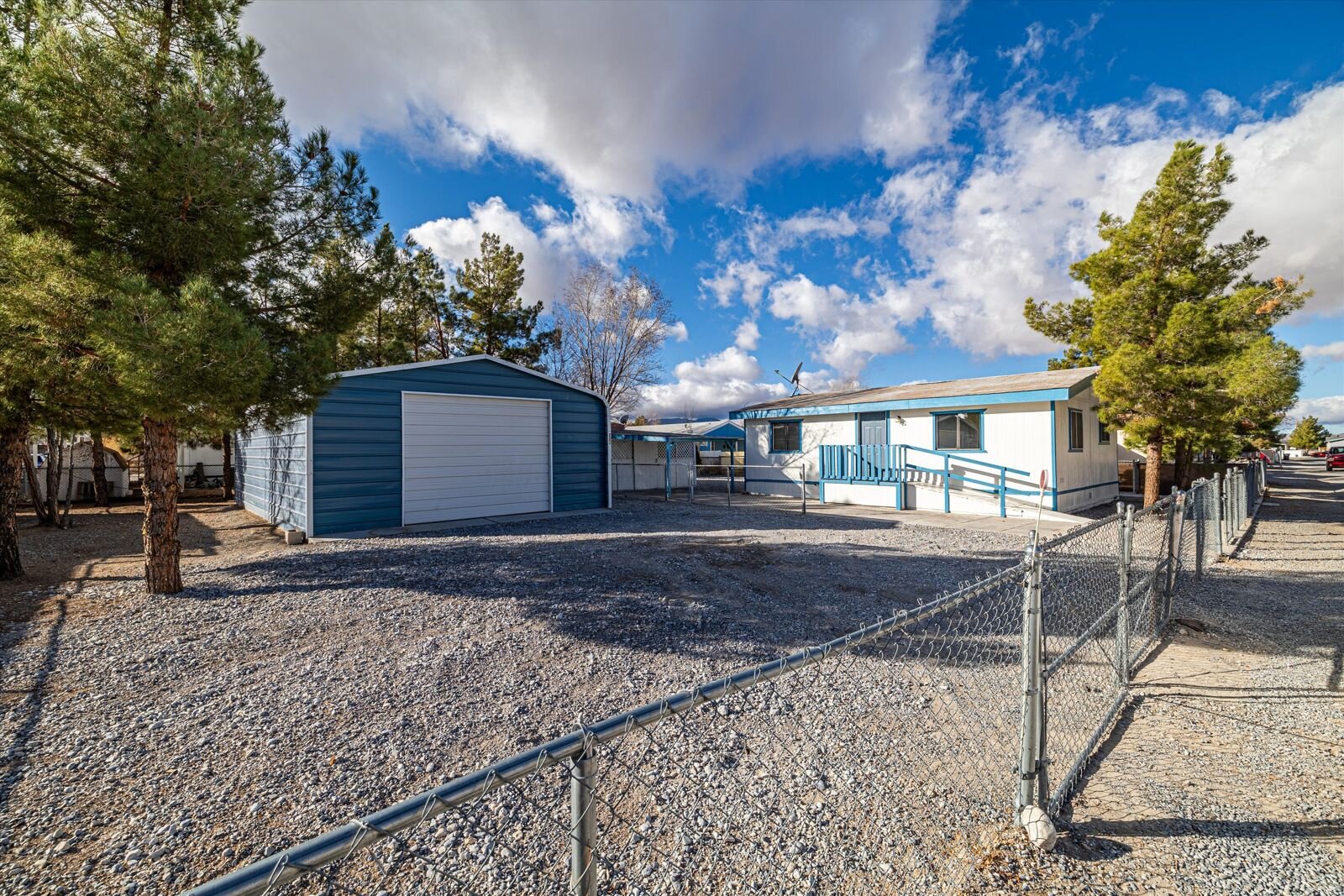 Manufactured home with a detached metal garage in Pahrump, NV, purchased by Fast Ready Offer