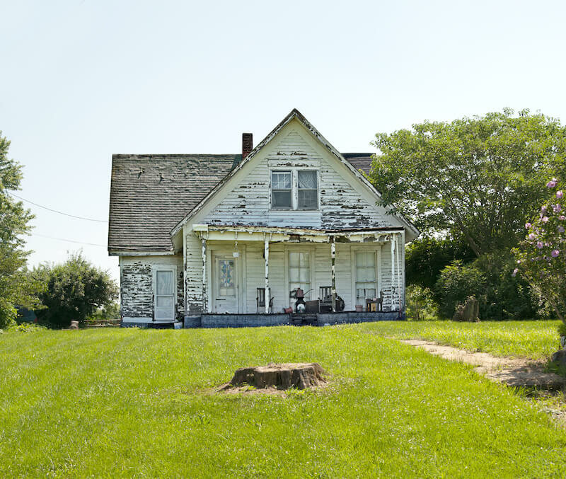 weather beaten flooded house for sale as is