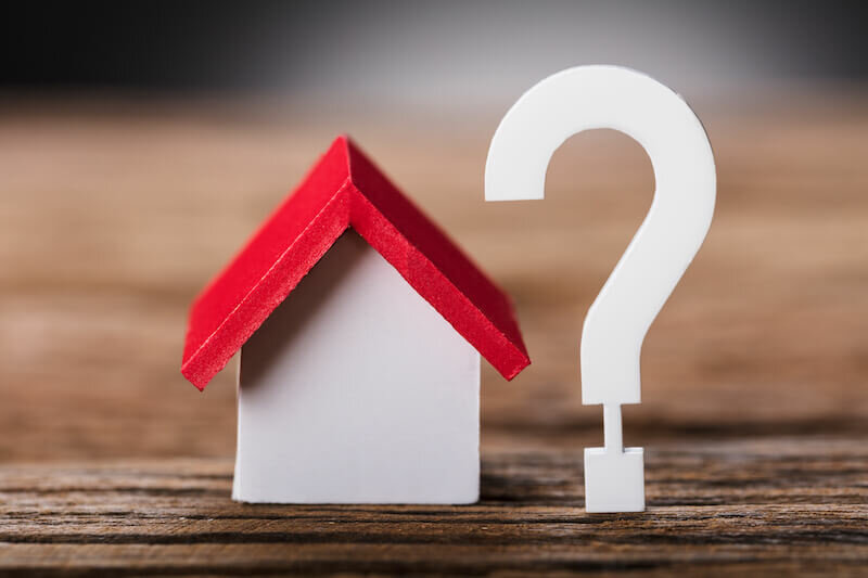 model house with a question mark beside it
