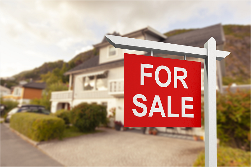 A recently inherited house for sale with a white and red "For sale" sign