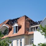 A house with a collapsed roof due to fire damage. Fixing the roof is extremely important if you're trying to repair fire damage in a house