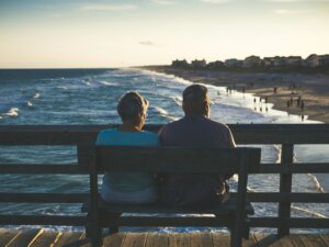 Florida couple on bench looking at the beach