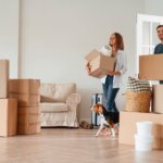 man and woman moving into new home