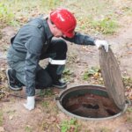 man looking at septic system