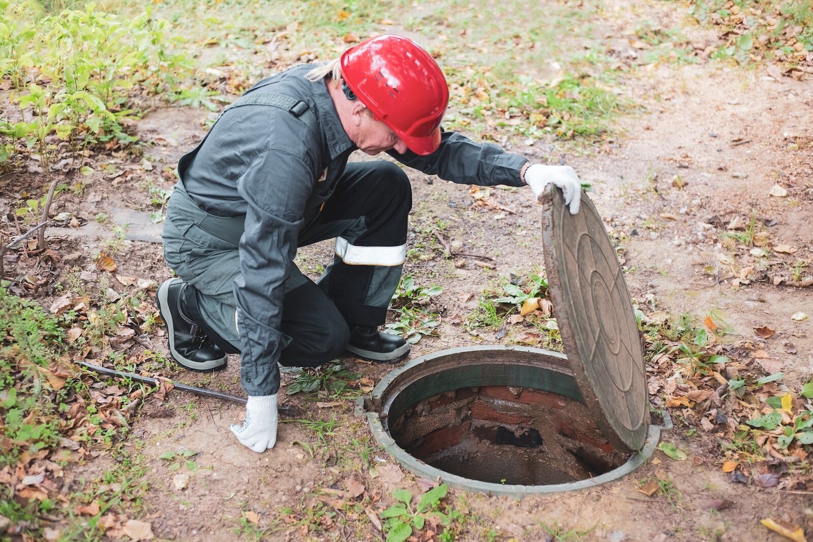man looking at septic system