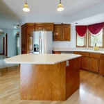home with wood kitchen cabinets and island