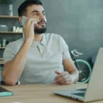 man talking on phone to sell house