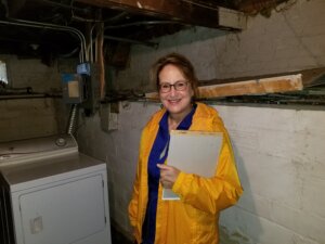 Anna of Anna Buys Houses evaluating a property for repairs and renovation.