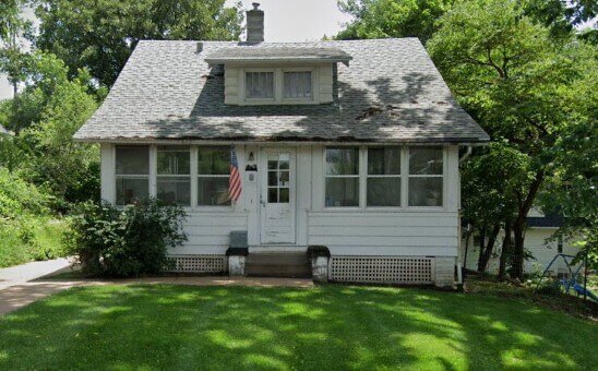 Small white house before rehab by Anna Buys Houses.