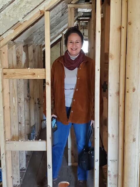 Anna Graham, founder of Anna Buys Houses in a house undergoing rehab.