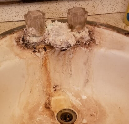 Calcified sink in an Anna Buys Houses property before rehab.