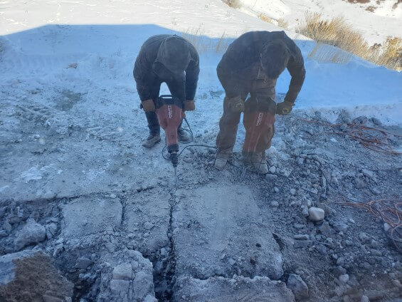 Workers repairing the foundation of a property in Wyoming.
