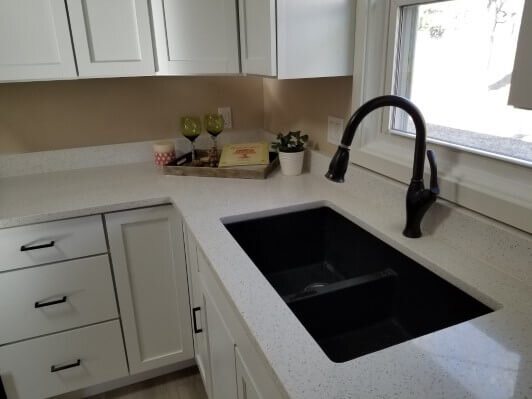 New kitchen sink and counters in an Anna Buys Houses remodeled house.