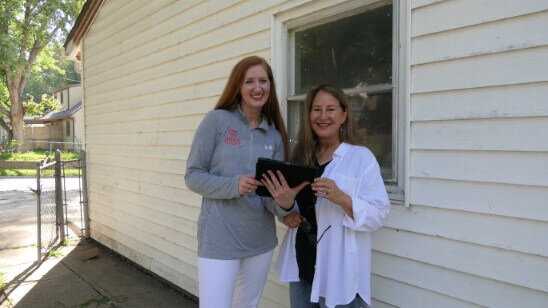 Anna Buys houses team members evaluating an Omaha property.