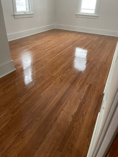 Bedroom with beautifully restored hardwood floors.