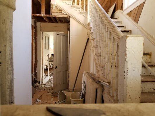 A vacant home filled with rubble and falling apart.