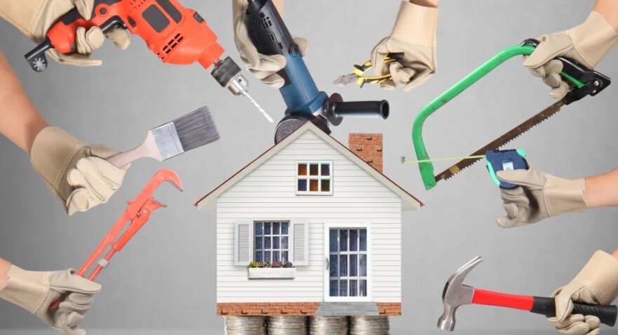 Picture shows a house about to go under renovations/repairs with coins stack beneath the house.
