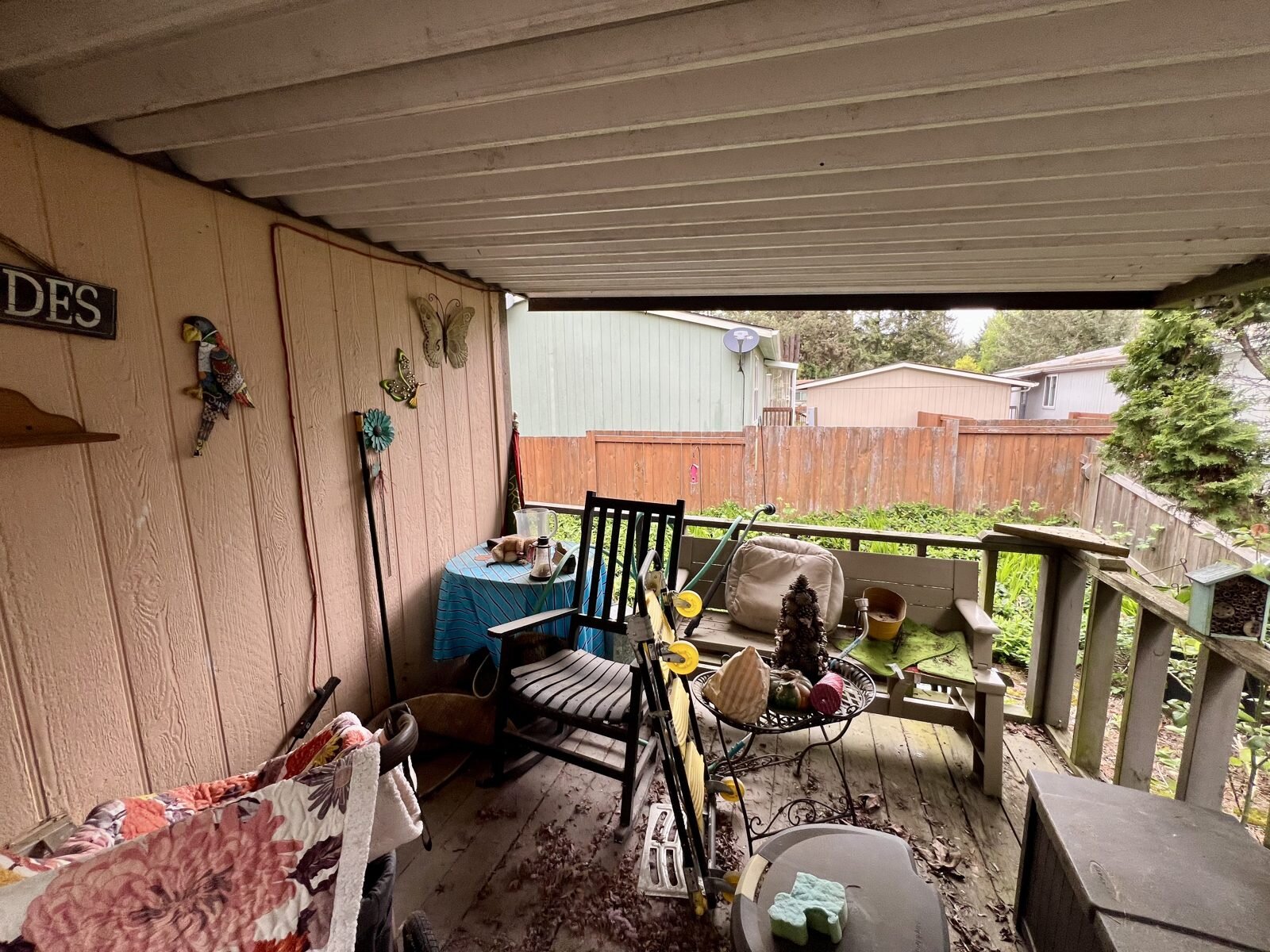 Covered back deck of the Albany manufactured home, still set up the way the seller lived in it