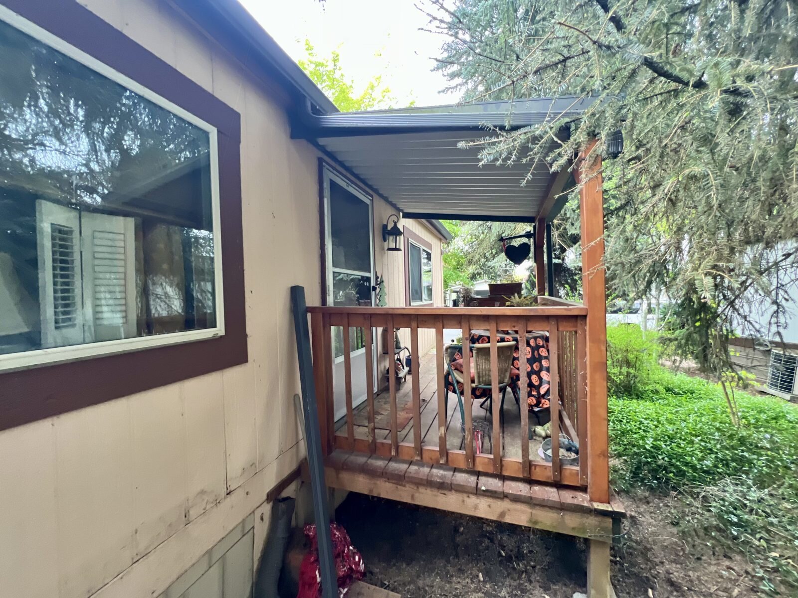 Covered wooden deck at the entry of the Albany manufactured home