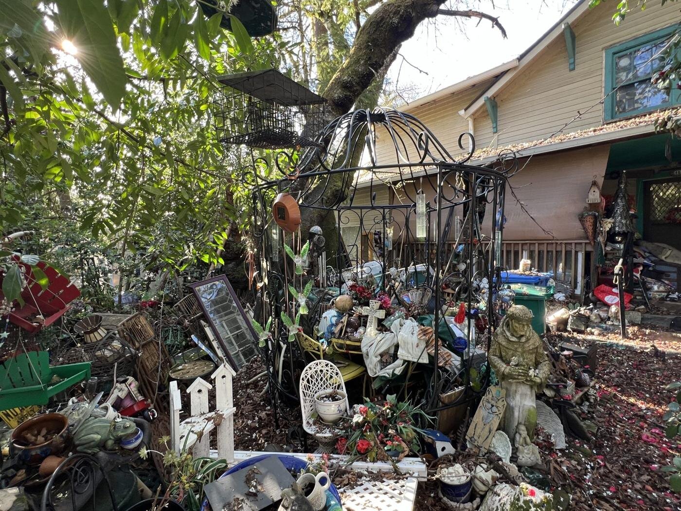 Front yard of the Milwaukie house filled with decorations, tools and belongings