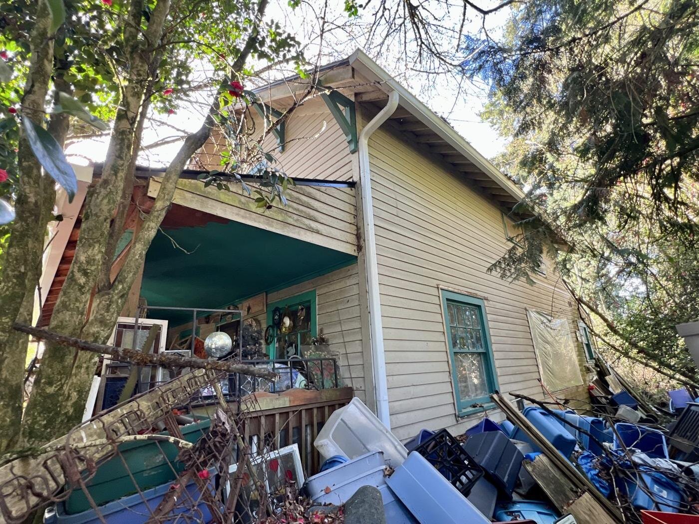 Side of the Craftsman house with belongings stacked against the wall