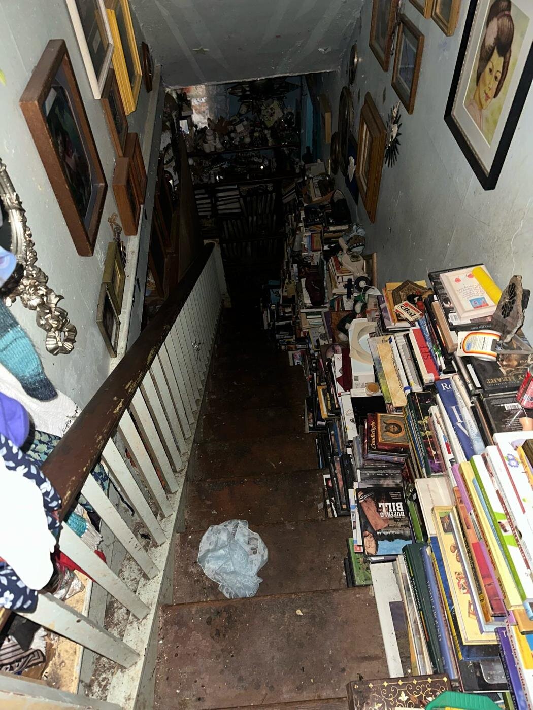 Stairway in the Milwaukie house lined with books and framed pictures