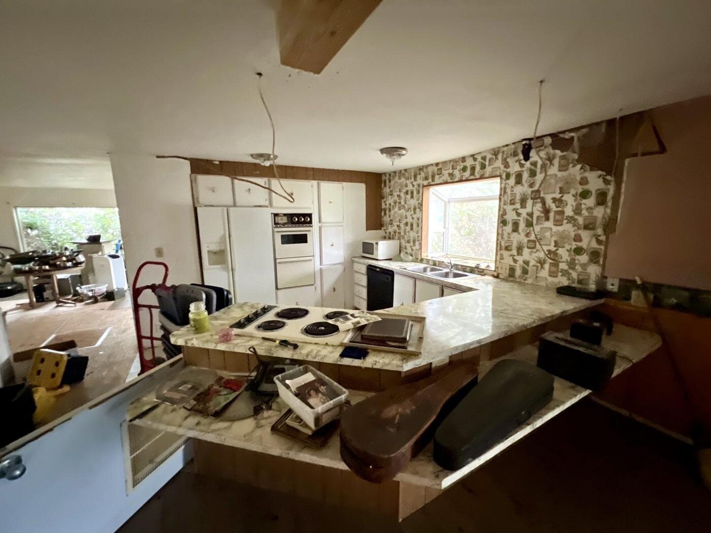 Kitchen counter with an old cooktop and items left behind