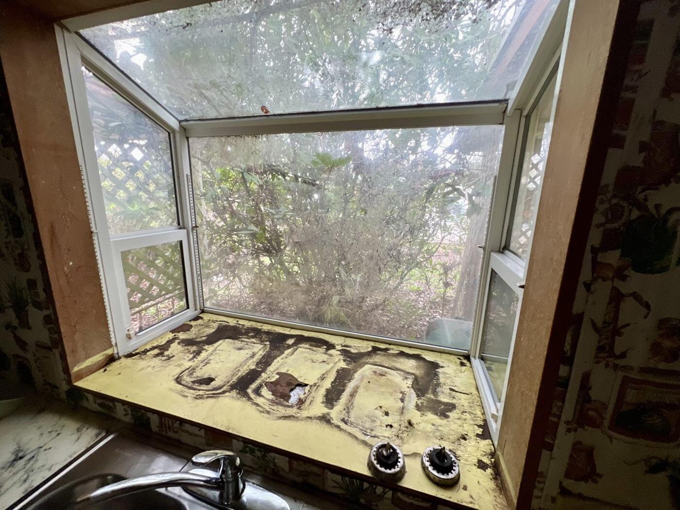 Kitchen bay window with a damaged sill in the Salem manufactured home