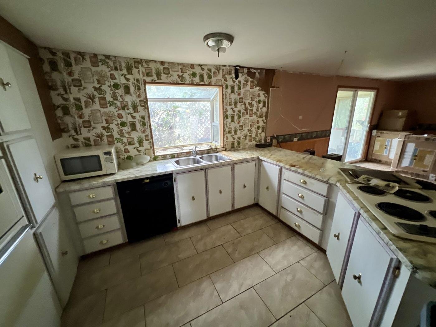 Kitchen of the Salem manufactured home with an L-shaped counter and white cabinets