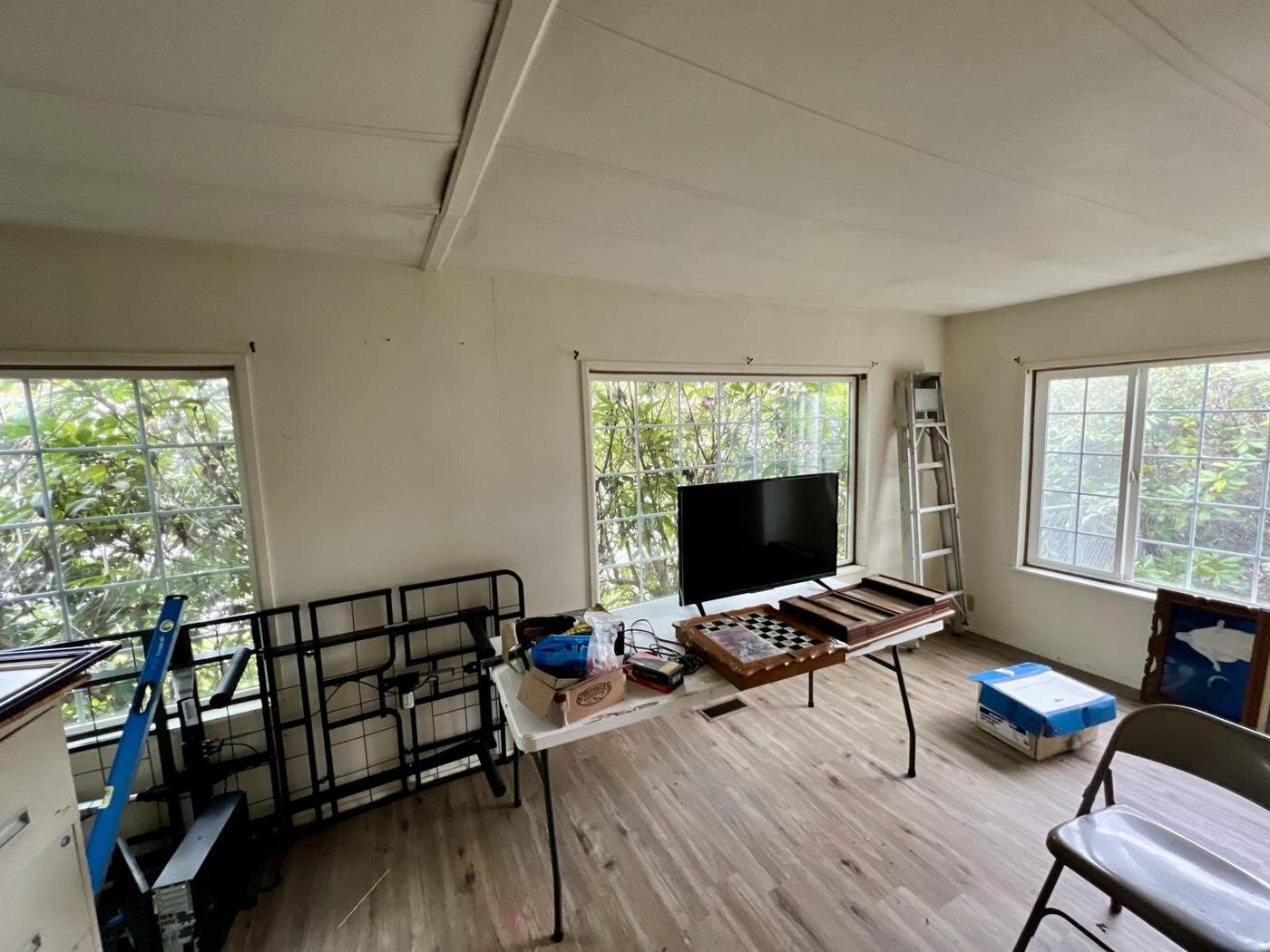 Living room of the Salem manufactured home with a TV and boxes on the floor