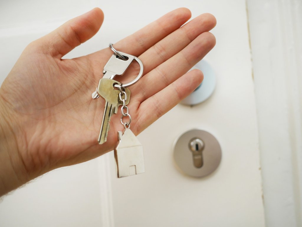 hand with giving keys back in Houston TX