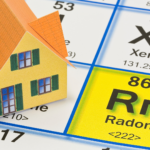 Model home on a periodic table highlighting the element Radon (Rn), signifying the importance of radon testing in residential properties.