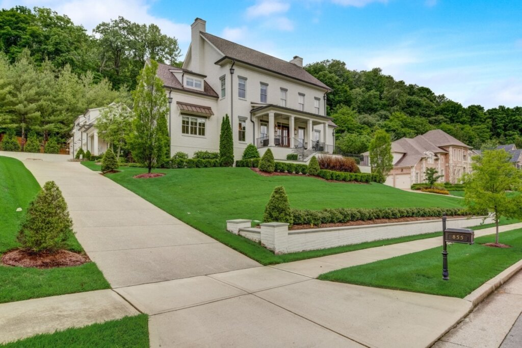 Big white house with driveway and lawn