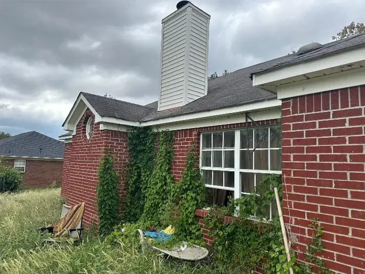 Older brick house with vines in Florence, AL that we can buy for cash as-is