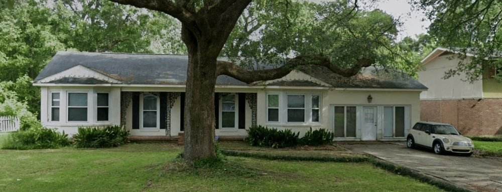 A tree in front of a house | Sell Your House Fast