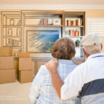 Senior couple hugging looking at packing their belongings.